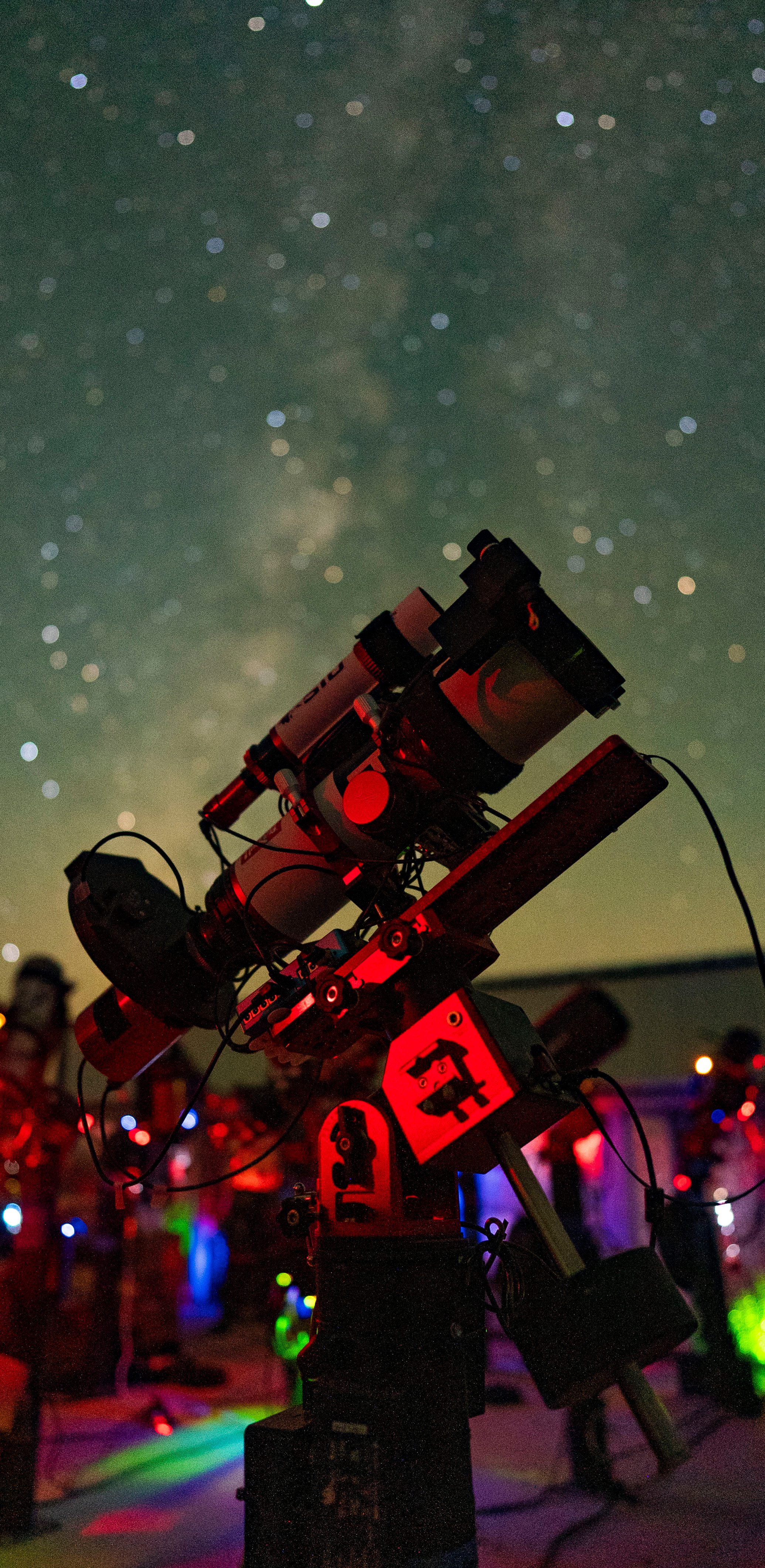 A telescope under a dark night sky